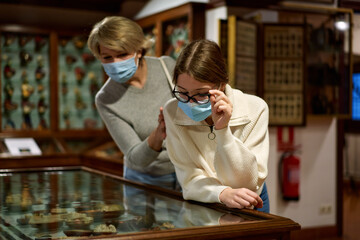 Woman and his daughter view the artworks