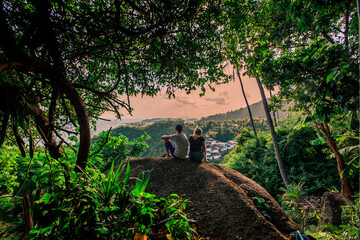 Background of mountains and nature surrounded, bright blue sky wallpaper. There are trees, green leaves, a beautiful ecology.