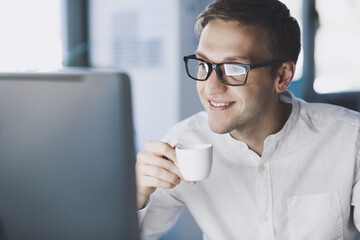 Businessman drinking coffee and smiling