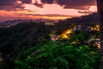 Background of mountains and nature surrounded, bright blue sky wallpaper. There are trees, green leaves, a beautiful ecology.