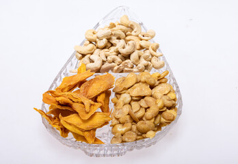 Roasted and salted fava beans, cashew nuts and dried mango slices for a healthy vegan and vegetarian diet snack. High in protein, vitamins, dietary fibre and nutrients