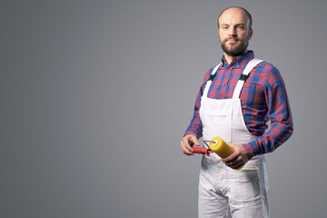 Professional painter posing with paint roller