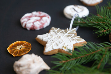 Christmas gingerbread in the form of a heart on a spruce branch. Christmas mood.