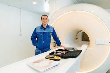installer engineer of mri apparatus with tools near scanner
