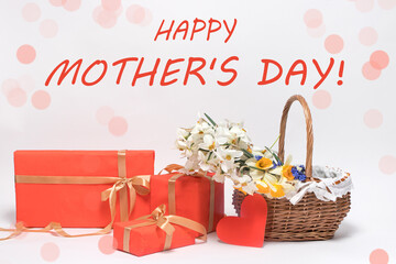 Beautiful card with the text Happy Mother's Day, boxes of gifts and a basket of flowers