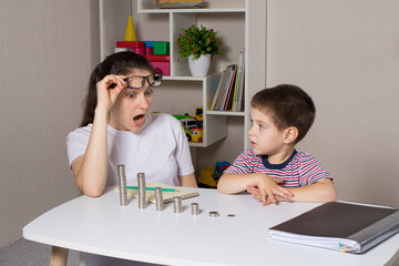 The parent teaches the child how to handle money. Financial literacy course for children of...