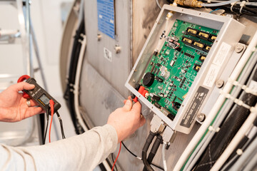 hands of engineer of the magnetic resonance imaging apparatus configure scanner.