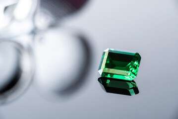 raw emeralds, gemstone jewelry on black background