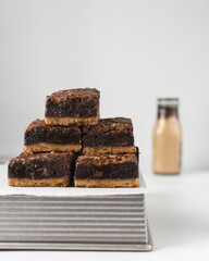Fudgy brownies on top more brownies, fudgy caramel brownies with a cookie crust, stack of brookies, thick brownie bars