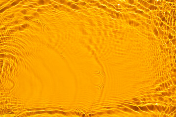 Aqua waves on orange background. Light and shadows. Water spills on a light orange background. Natural sunlight and shade. Beautiful bursts, waves, drops, streaks, highlights, glare. Summer mood
