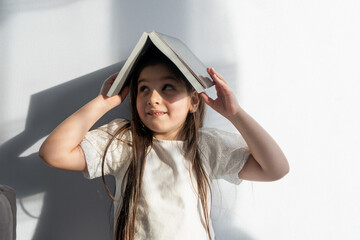 girl with a book on her head