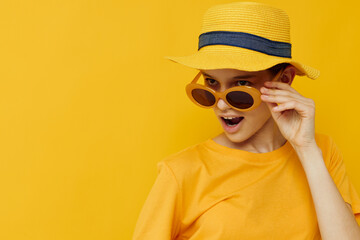 young woman in a yellow hat Youth style casual wear in sunglasses isolated background