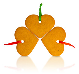 Three Christmas gingerbread heart cookies isolated