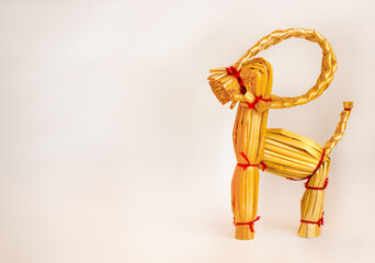 Scandinavian christmas straw goat on a light background with copyspace