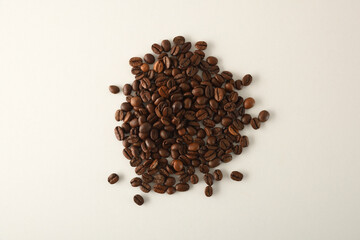 Pile of coffee beans in the center of white table