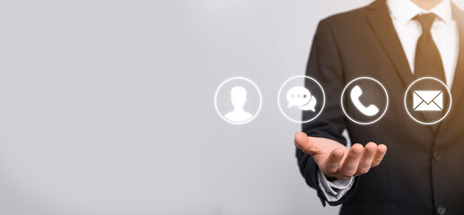 Businessman hand holding,pressing on icon phone, mail, telephone,message,post and person,user. Customer service call center contact us concept.Banner,copy space.Contact Methods.