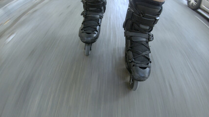 Close up on a skates of a man roller skating on the street, passing by the car. Motion blur on the road, focus on the back skate