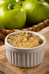 Apple crumble in ramekin on the table.