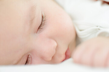 Baby newborn sleeping on the white blanket