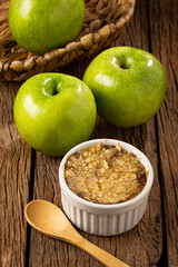 Apple crumble in ramekin on the table.