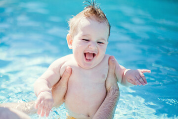 Baby boy swimming at pool