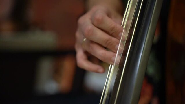 Close up shot hand playing music with chelo 