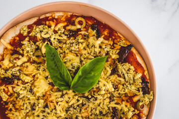 vegan pizza with dairy-free cheese sundried tomatoes and olives, healthy plant-based food