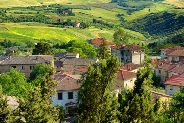 Fototapeta na wymiar Stunning surroundings of medieval town of Volterra, known fot its rich Etruscan heritage, located on a hill overlooking the picturesque landscape. Tuscany, Italy.