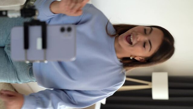 Vertical shoot. Teenager girl dancing, when making video for social media, stories hip hop popular trandy dance, students at home make content for video-focused social networking service. 4k footage