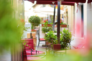 Empty restaurant table in medieval street of Montalcino town, located on top of a hill top and surrounded by vineyards, known worldwide for the production of wine. Tuscany, Italy.