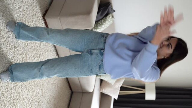 Teenager girl dancing, when making video for social media, stories hip hop popular trandy dance, students at home make content for video-focused social networking service. Vertical shoot. 4k footage