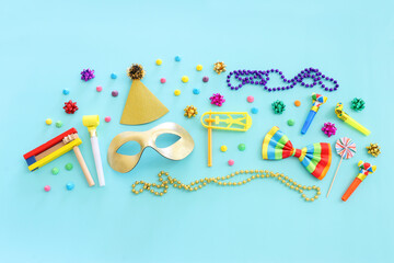 Purim celebration concept (jewish carnival holiday) over blue wooden background