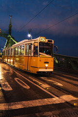 Tram crossing the bridge during night