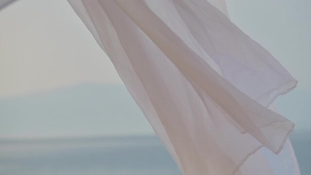 White pergola curtains at seaside, slow motion