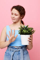 portrait of a young woman potted flower posing plant pink background unaltered