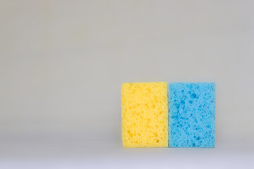 two sponges for cleaning. yellow, blue colors. space for text.
Kitchen cleaning set sponge background. sponge in woman's hand. space for text. 