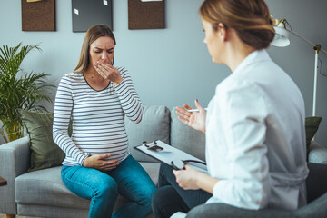 Young pregnant woman talking with doctor. Pregnant Woman Coughing.  Woman during a routine check up with her doctor at home. The concept of pregnancy and pain. Having chest pain and breathing issues.