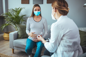 A pregnant woman holds a thermometer for temperature. Influenza treatment. Sick female at home....