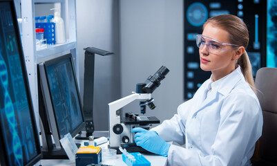 Female doctor works in a modern scientific laboratory using equipment and computer technologies....