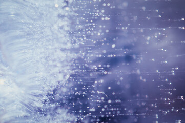 Abstract ice texture. Small bubbles with tails. Abstract nature background. Colorful Background of blue ice inside.