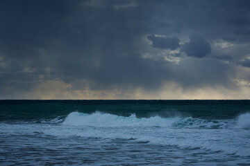Storm clouds over the sea are black and blue. A hurricane is coming, a downpour. Natural sinister background. Storm warning. Weather disasters. The sea is a gloomy landscape. Gloomy seascape