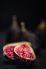 cut fig with figs in background