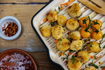 cooked scallops on wooden board on gridle pan