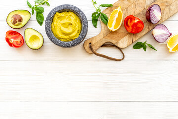 Homemade guacamole avocado dip with tomatoes and lime
