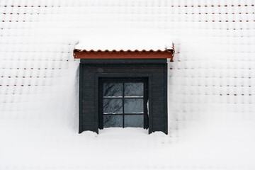Dormer on a roof under fresh snow