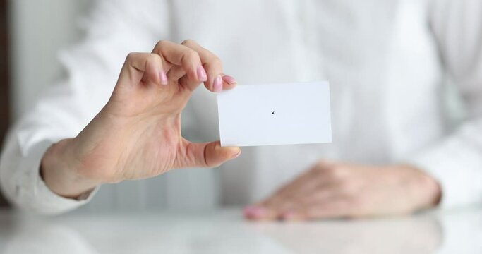 White business card in hands of business person closeup