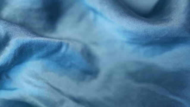 Texture Blue Shiny Mulberry Silk Fabric, Closeup, Macro. Smooth Luxurious Silk Material, Premium High Quality Textile. Abstract Shiny Blue Silk Background. Silk Production.