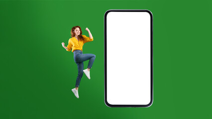 Woman Jumping Near Big Smartphone Screen Gesturing Yes, Green Background