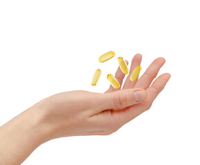 Omega 3 pills floating over female hand isolated on white background. Healthcare and treatment concept
