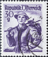 Austria - circa 1950 : a postage stamp from Austria, showing a woman in national costume from the region: Salzburg, Pongau